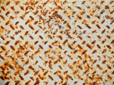 Detail of grated metal surface white and rusty orange texture