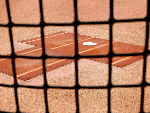 Baseball practice area fence with home plate for warm up pitching