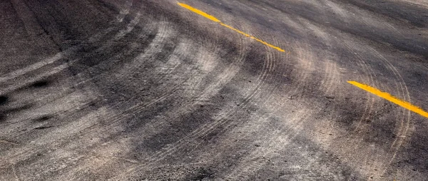 Marcas Neumáticos Girando Carretera Con Líneas Rayas Amarillas — Foto de Stock