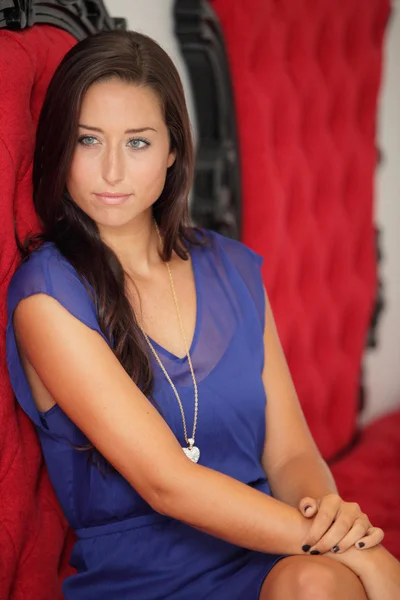 Woman on a red chair — Stock Photo, Image