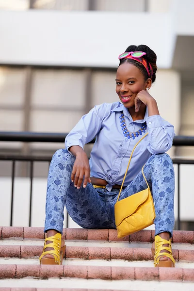 Jamaican woman sitting on a staircase — Stock Photo, Image