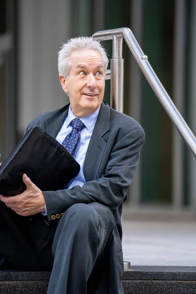 Geschäftsmann Sitzt Auf Einer Treppe Und Blickt Über Die Schulter — Stockfoto