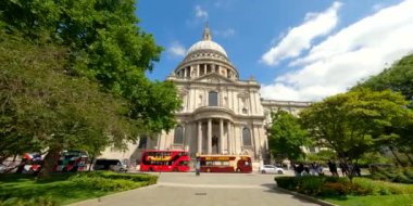 Motion video double decker busses in front of St Pauls Cathedral London UK