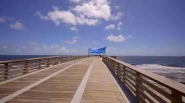 Walking on the Pompano Beach fishing pier. 4k gimbal stabilized motion video