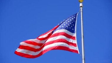 8k video of the American Flag on blue sky