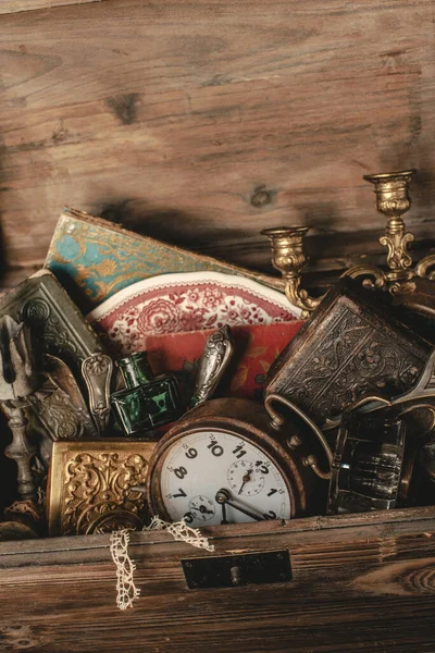 Antique treasures in a wooden box at a flea market
