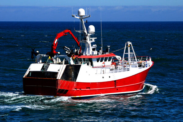 Fishing boat underway at sea to fishing grounds.