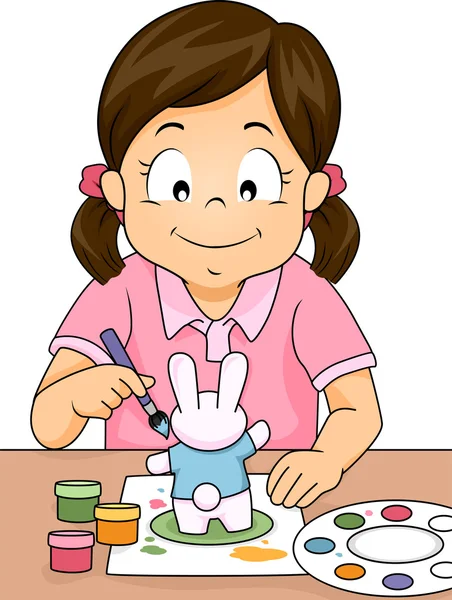 Menina pintando uma figura de coelho — Fotografia de Stock