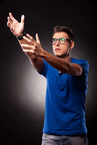 Young casual man holding his hands up — Stock Photo, Image