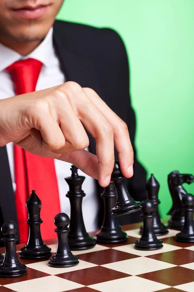 Business man playing chess black makes first move — Stock Photo, Image