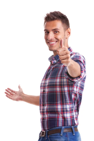 Jovem casual homem mostrando polegar para cima e sorrindo — Fotografia de Stock