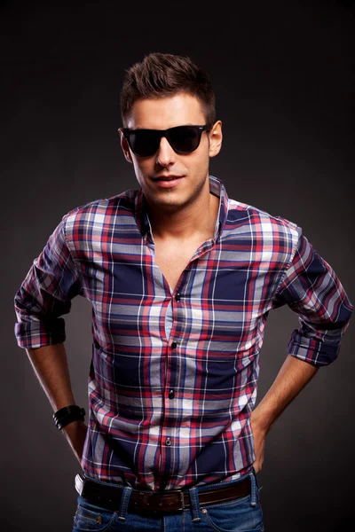 Young casual model wearing sunglasses,facing the camera Stock Picture