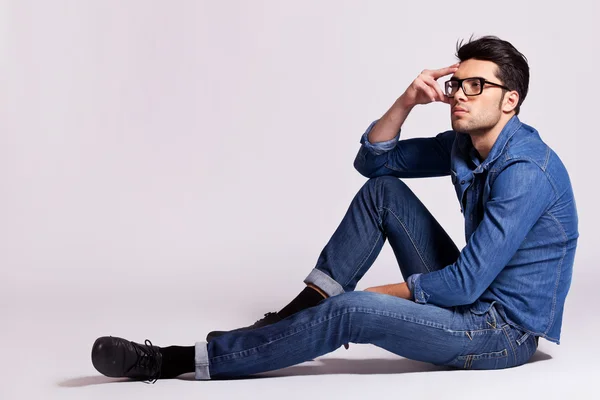 Fashion man sitting and thinking — Stock Photo, Image