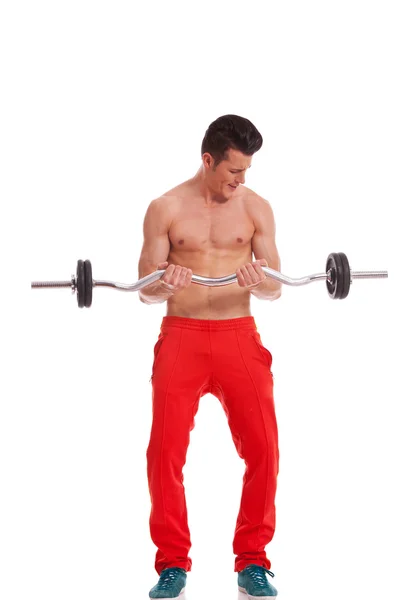 Ripped young man lifting a barbell — Stock Photo, Image