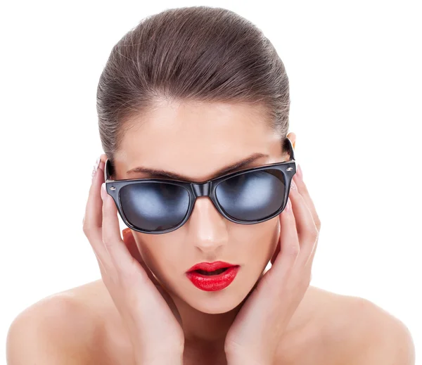 Mujer joven enderezando sus gafas de sol —  Fotos de Stock