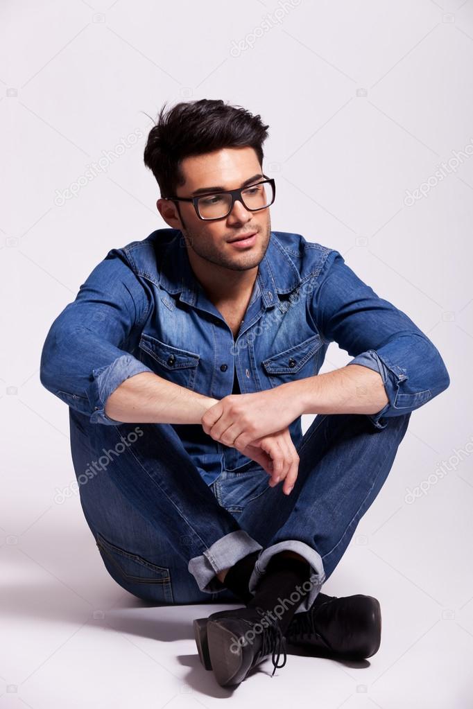 man wearing jeans shirt and glasses, sitting