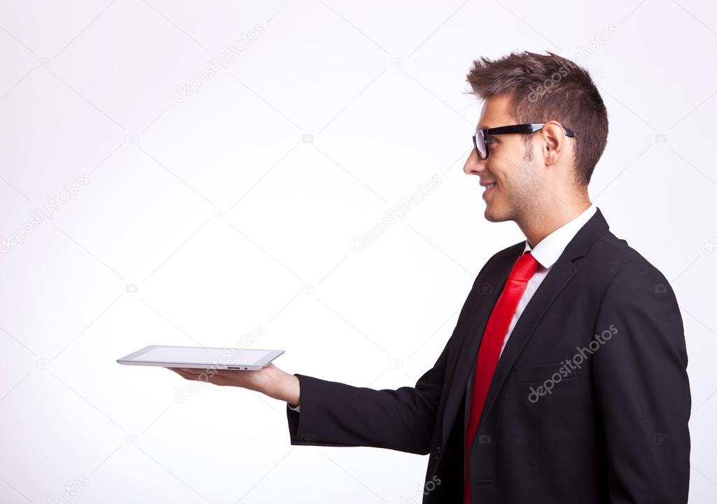 young business man holding a touch screen pad