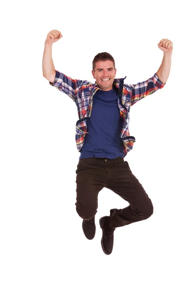 Young happy man is jumping in air — Stock Photo, Image
