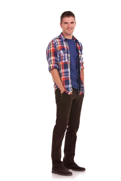 Young man with hands tucked in pockets — Stock Photo, Image