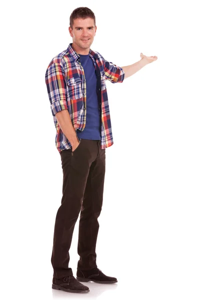 Casual man presenting with hand in pocket — Stock Photo, Image