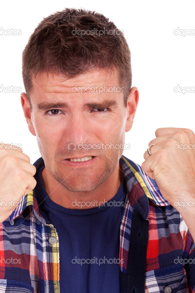frustrated young man shows fists