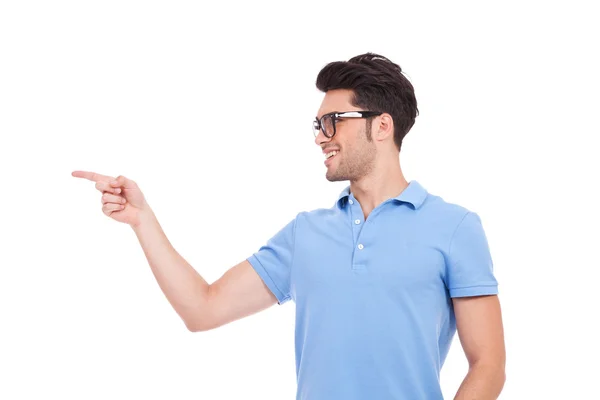 Young man with glasses pointing — Stock Photo, Image