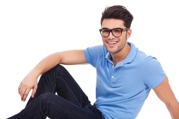 Young man laying on floor and smiling — Stock Photo, Image