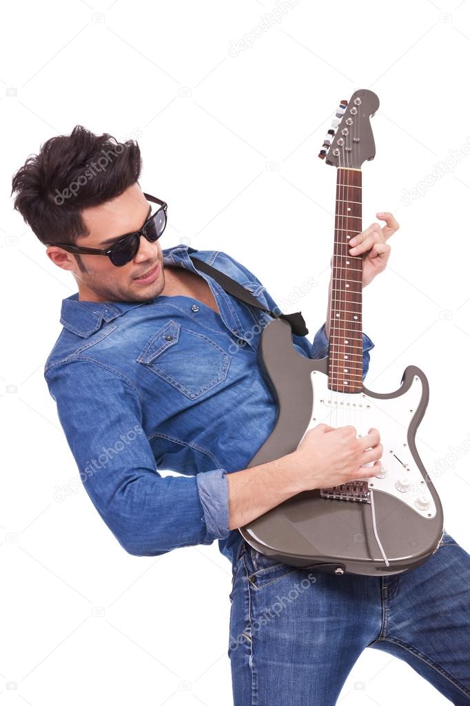 young man plays electric guitar