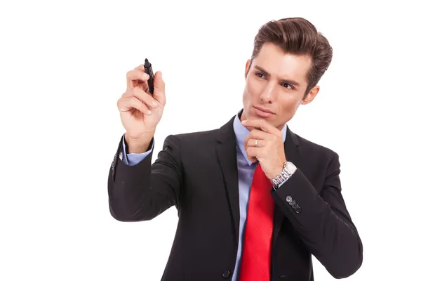 Pensive business man is writing something — Stock Photo, Image