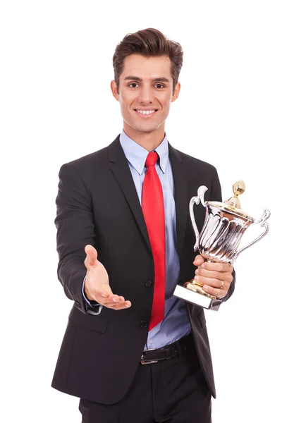 business man handing a trophy and handshaking