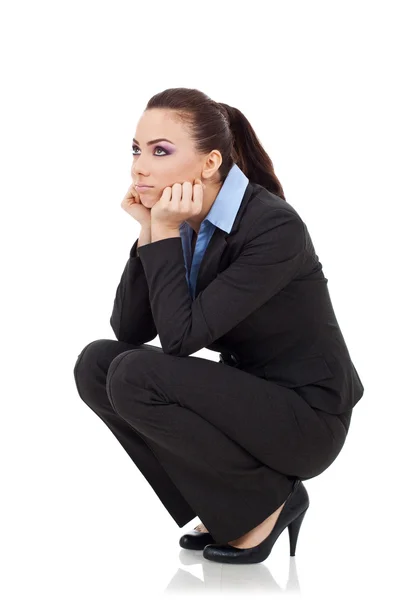 Squating woman looking up Stock Image