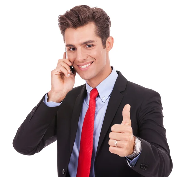 Business man talking on the smart phone and making ok Stock Picture