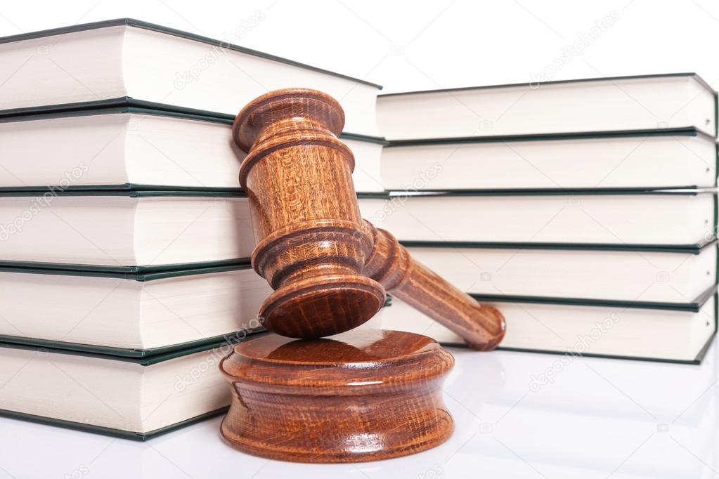 law books and a wooden judges gavel
