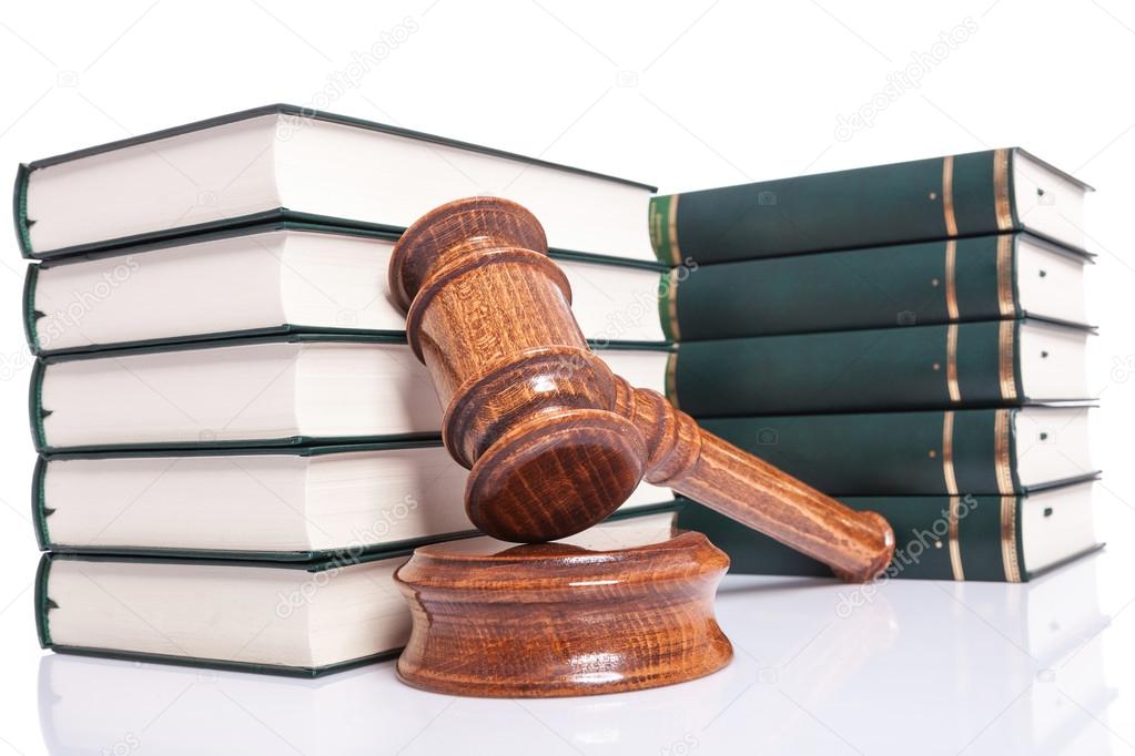 Judges wooden gavel leaning against law books