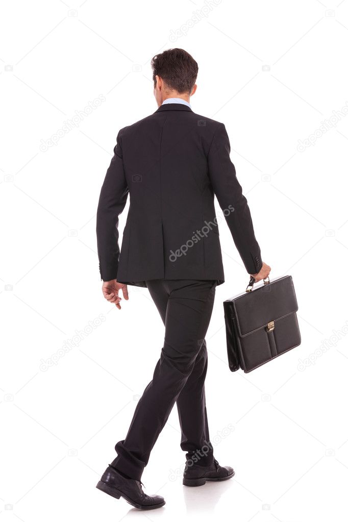 back view of a walking business man with briefcase
