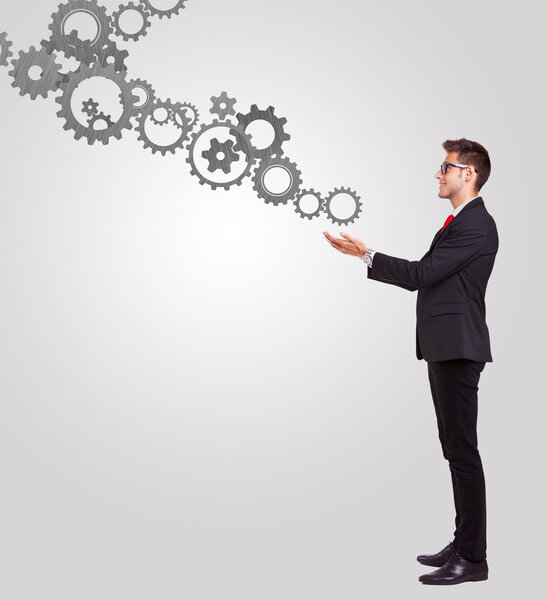 Деловой человек с некоторыми механизмами винтиков
