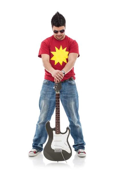 Rocker holds guitar between legs — Stock Photo, Image