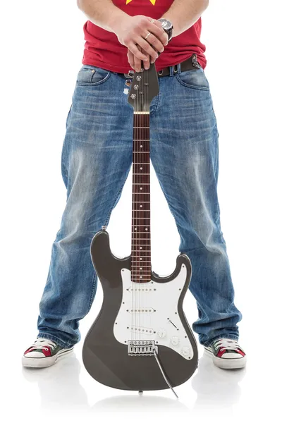 Casual man guitar between legs — Stock Photo, Image