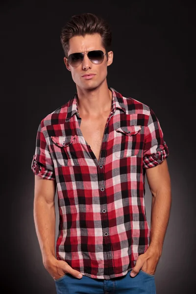 Fashion man wearing sunglasses with hands in pockets — Stock Photo, Image