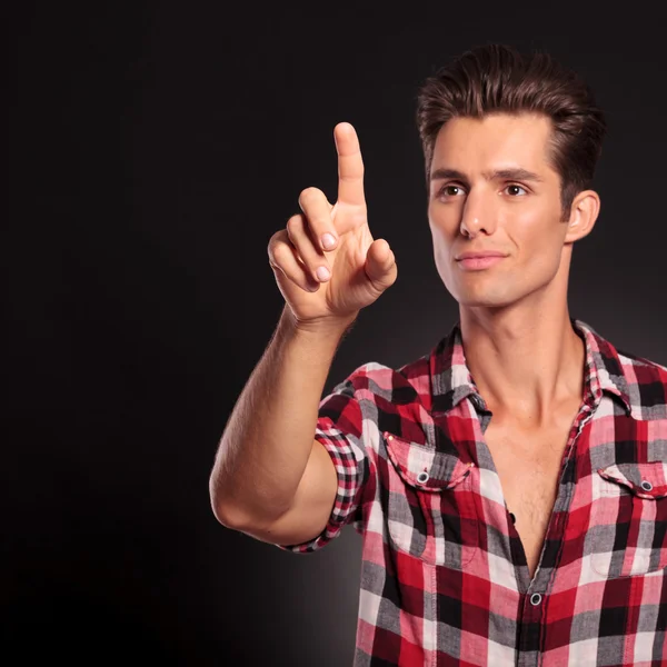 Happy casual man pushing a virtual button — Stock Photo, Image