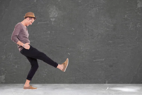 Young man kicking and smiling — Stock Photo, Image