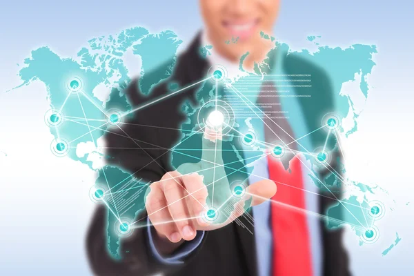 Smiling business man making worldwide connections — Stock Photo, Image