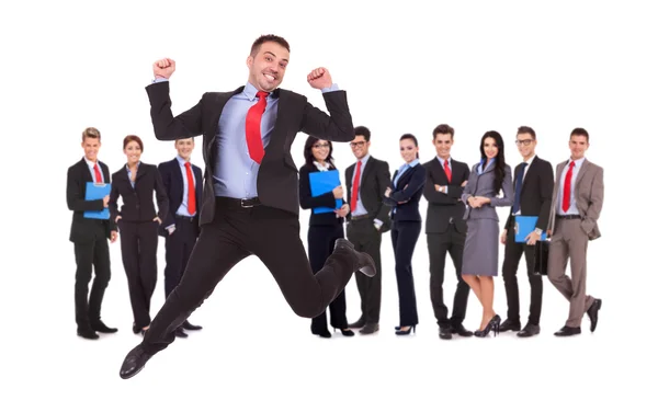 Business man jumping in front of his business team Stock Photo