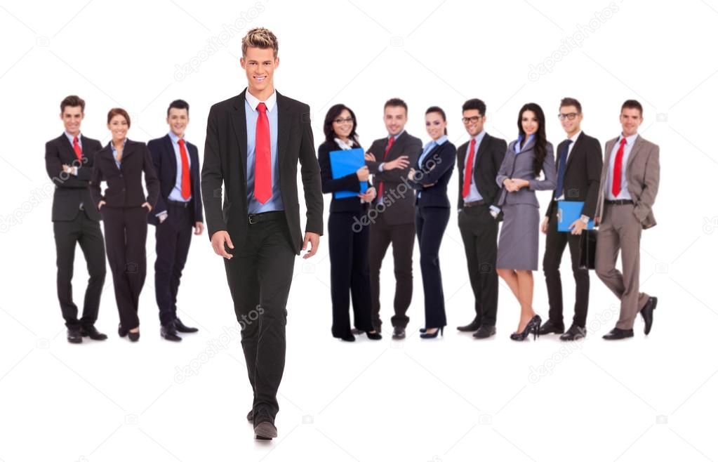 business team with a business man walking forward