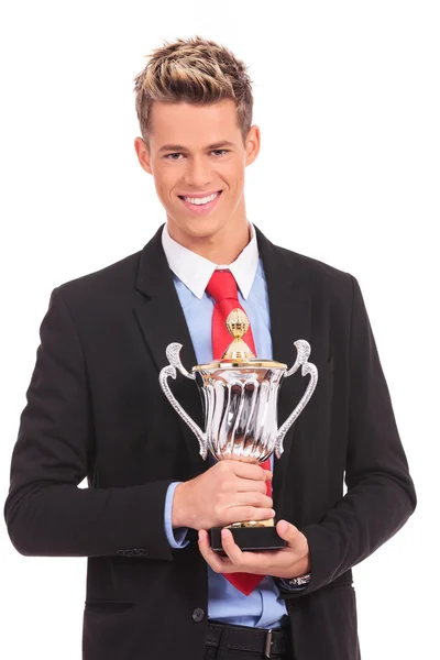 Affärsman med vinna cup i hand — Stockfoto