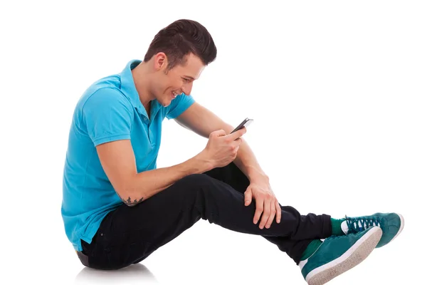 Young man writes an sms — Stock Photo, Image