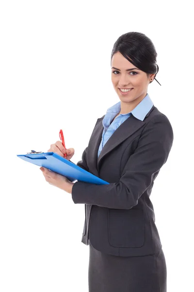 Businesswoman writing on clipboard — Stock Photo, Image