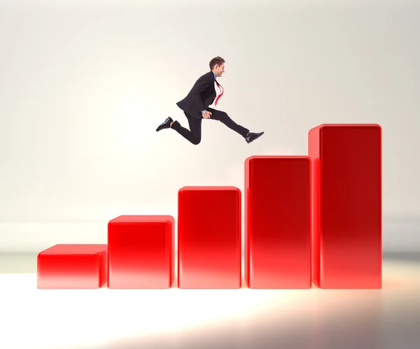 Business man jumping on a 3d graph — Stock Photo, Image