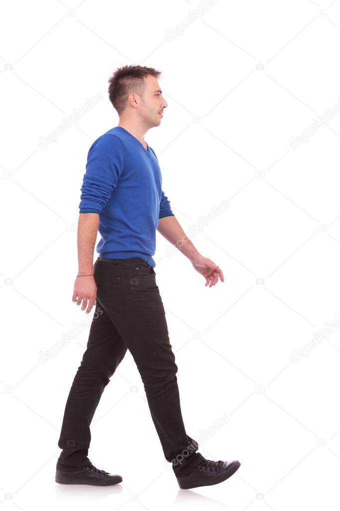 young casual man walking forward