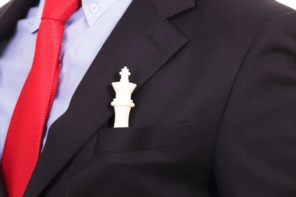 White chess king in black suit pocket — Stock Photo, Image